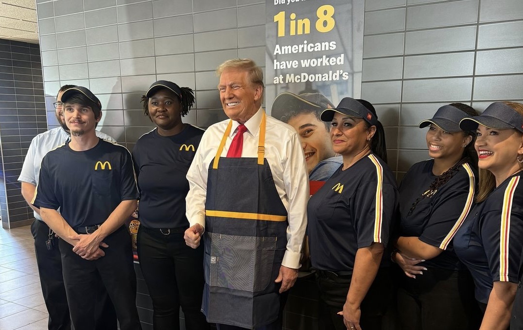 Empleado sonriente con grupo de trabajadores de McDonald's