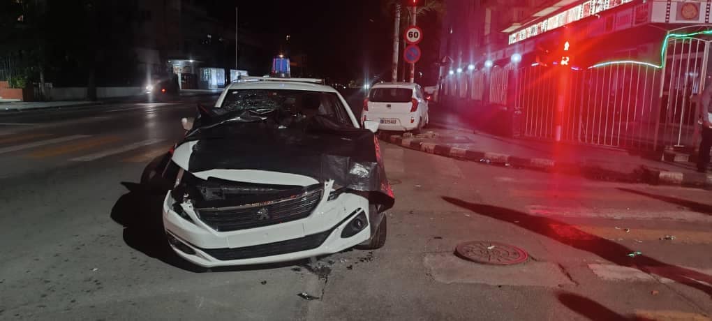 Coche blanco accidentado en carretera nocturna