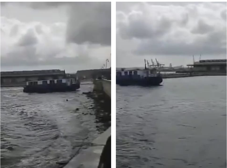 Barcaza navegando en río con muelle industrial