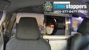 Conductor con mascarilla en coche con logo de NYPD