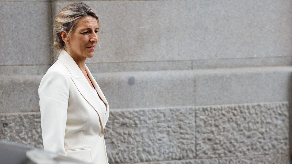 Mujer en traje blanco caminando sonriente