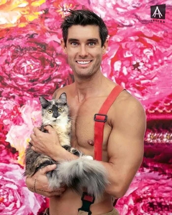 Hombre sonriente sostiene gato con fondo floral