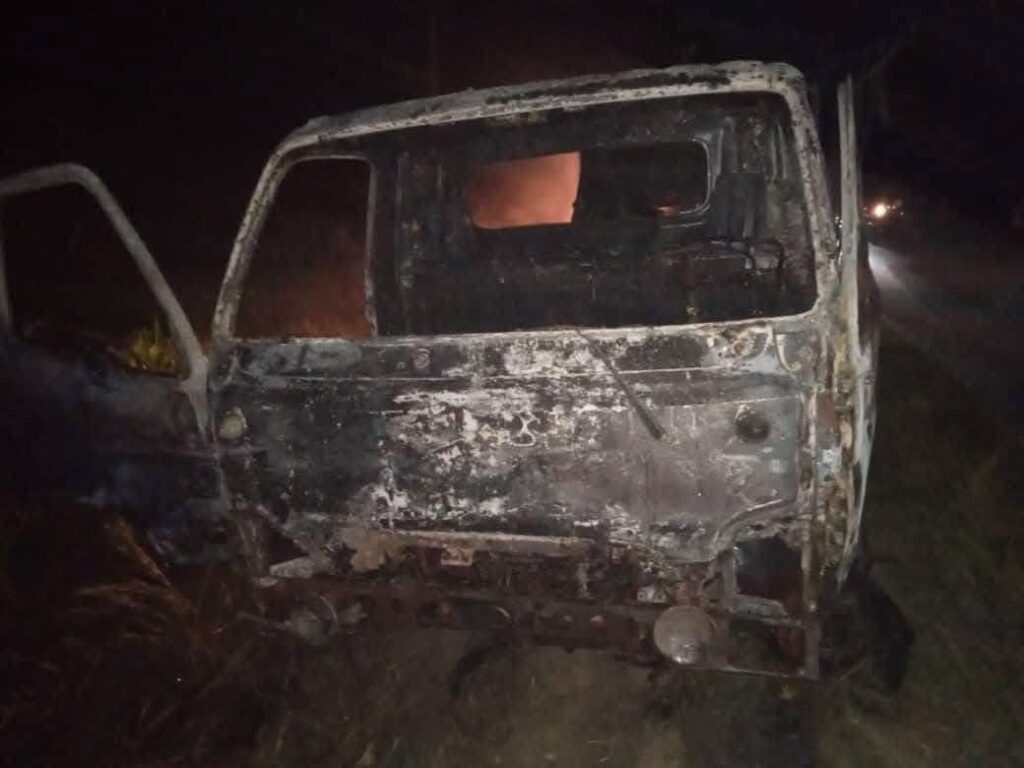 Furgoneta calcinada en carretera nocturna