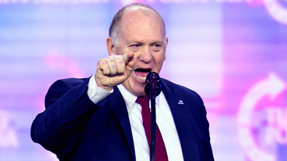 Hombre señalando mientras habla al micrófono