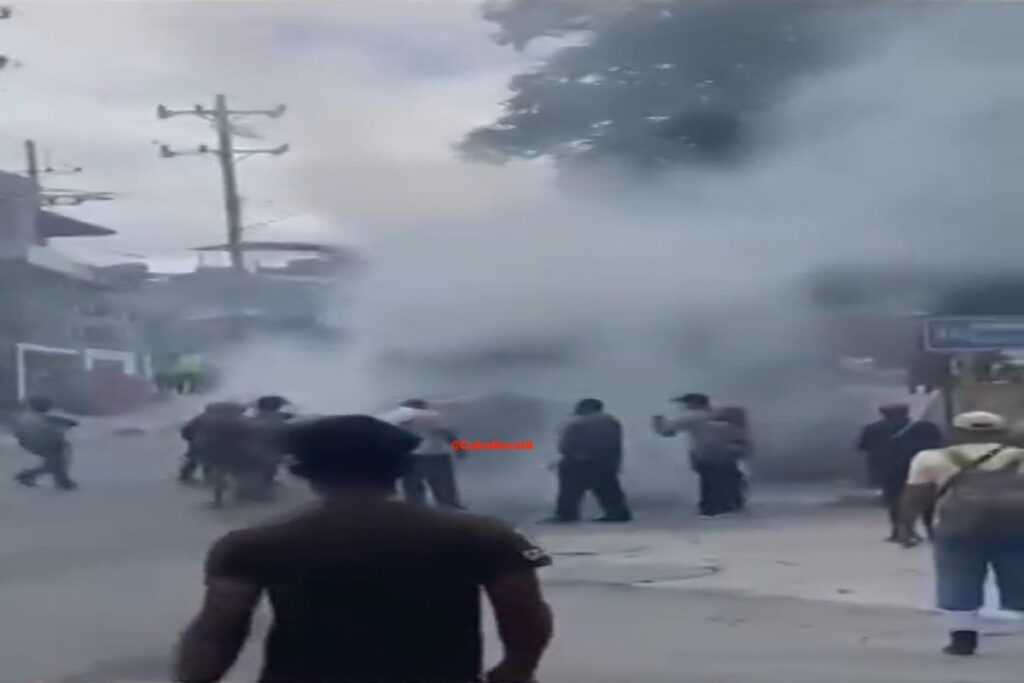 Personas corriendo en calle con humo