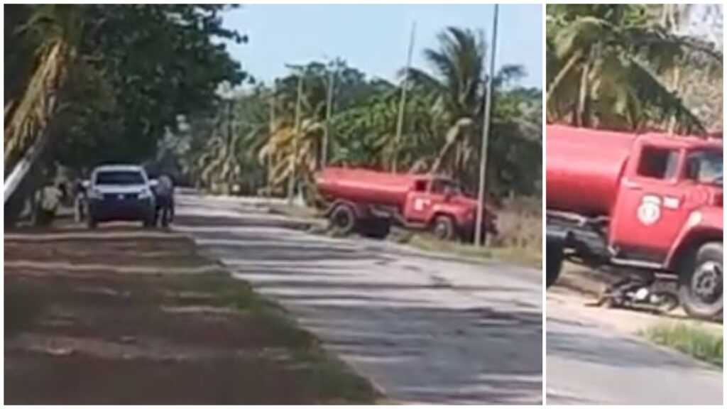 Camión cisterna rojo estacionado en carretera rural.