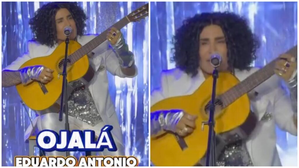 Cantante tocando guitarra en escenario iluminado.