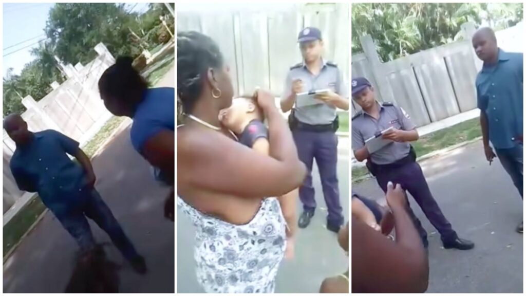 Personas hablando con policías en la calle.