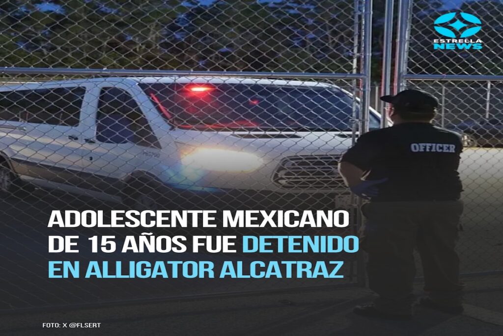 Oficial y vehículo ante reja cerrada de noche.