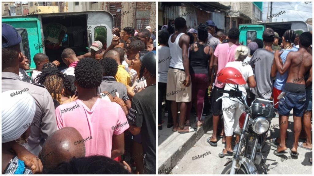 Multitud reunida alrededor de un vehículo estacionado.