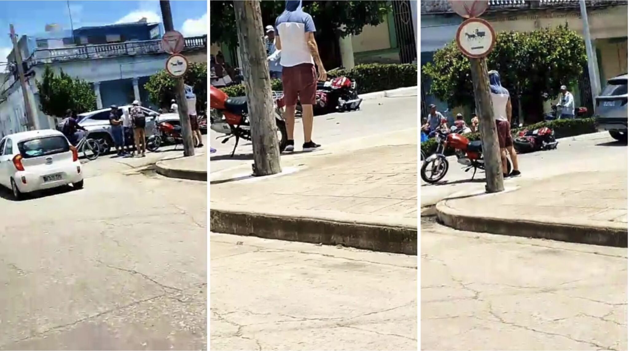 Accidente de motos y coches en intersección urbana.