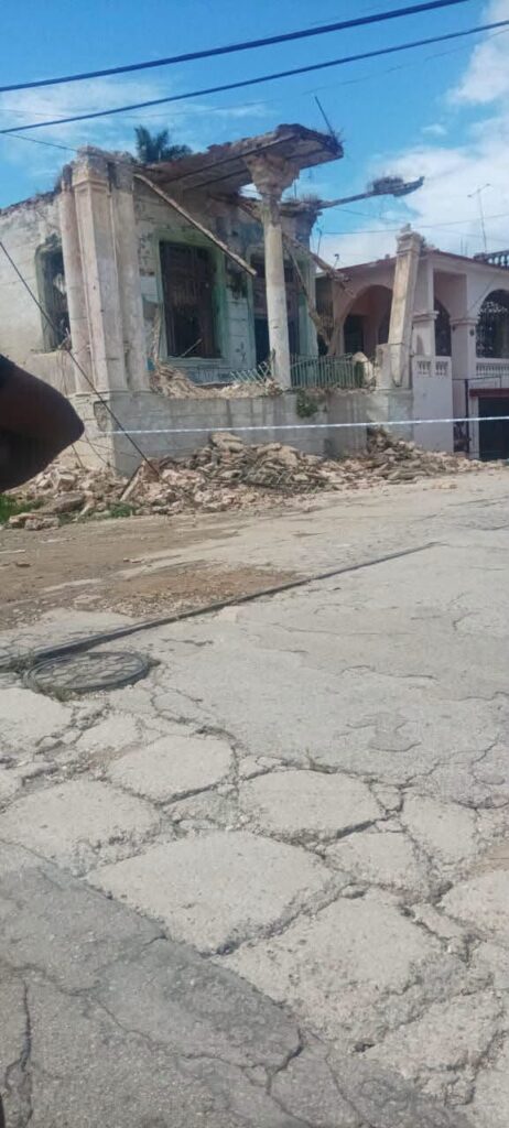Edificio en ruinas con escombros acumulados tras un derrumbe.