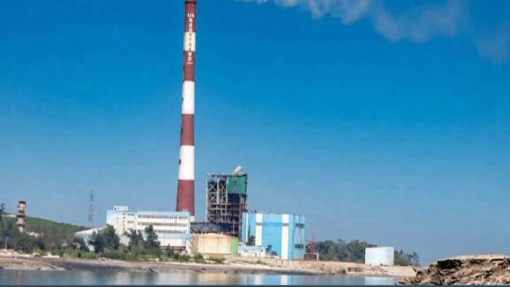 Planta industrial con chimenea de franjas rojas y blancas.