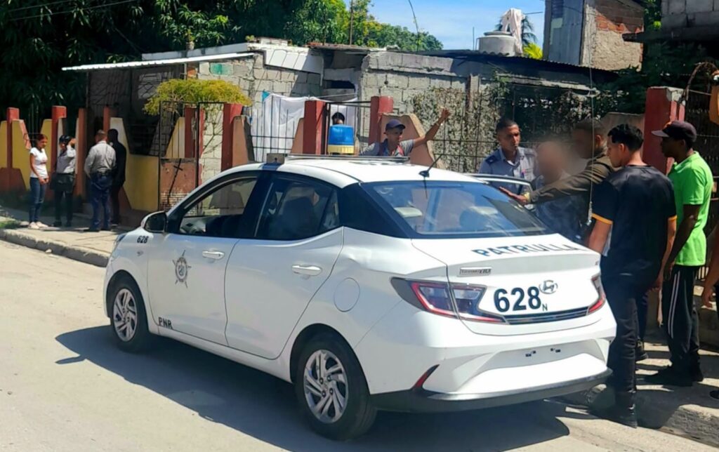 Coche de patrulla PNR blanco aparcado en una calle.